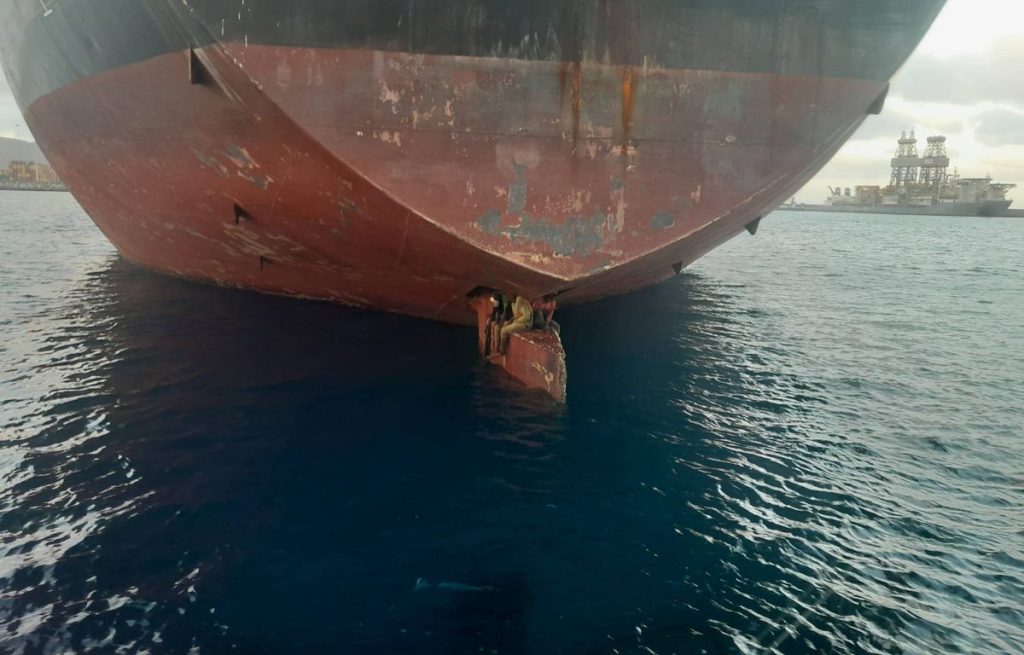 Three illegal immigrants, who arrived hidden under the back of an oil tanker, seek asylum